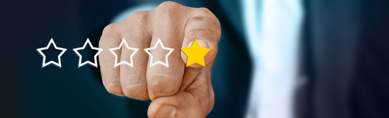 Man's finger selecting a one-star review rating