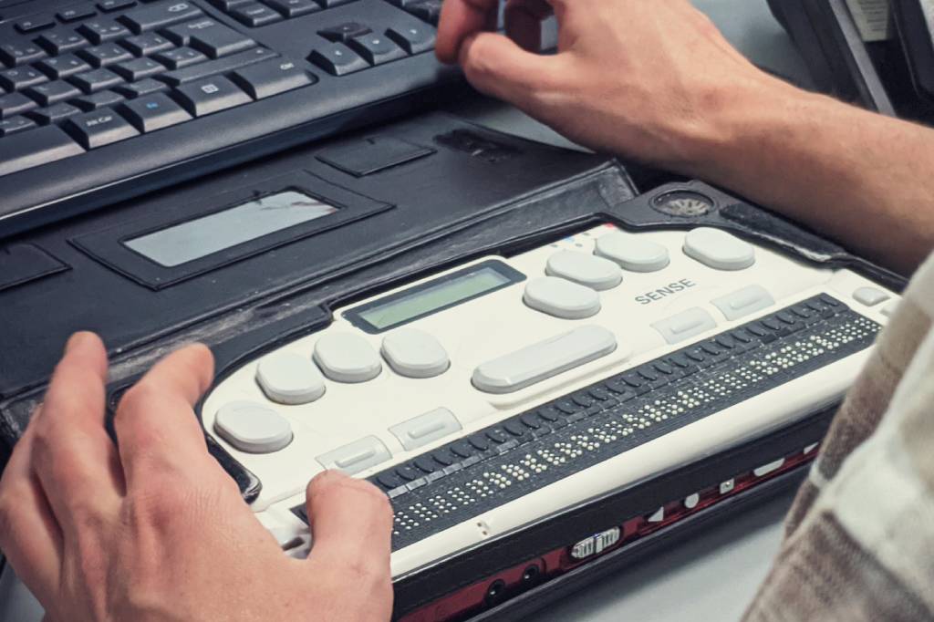 Braille Writer and a laptop demonstrating web accessibility