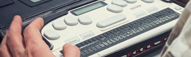 Braille Writer and a laptop demonstrating web accessibility