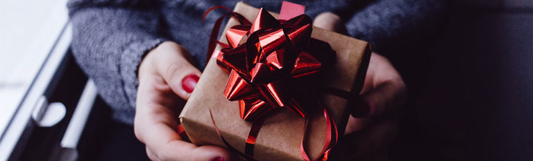 Lady presenting Free gift wrapped product